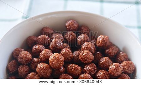 Top View Of Chocolate Cornflakes In A Bowl, A Breakfast Cereal Made By Toasting Flakes Of Corn Or Ma
