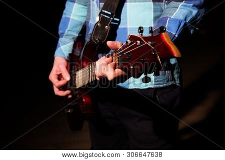 Hands Of Man Playing Electric Guitar In Red Light. Bend Technique