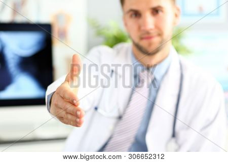 Focus On Male Hand Demonstrating Some Goods Or Things. Doctor Stretching Arm To Visitor. Medical Tre