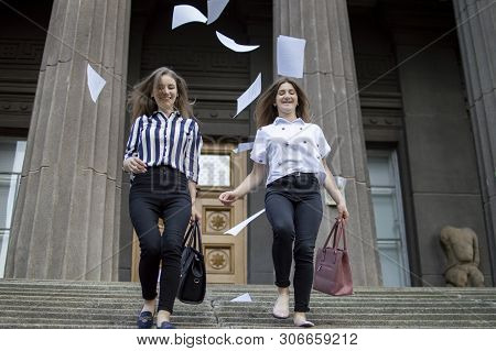 Two Young Happy Students Passed Exams And Leave Home For School, They Run Up The Stairs And Throw Aw