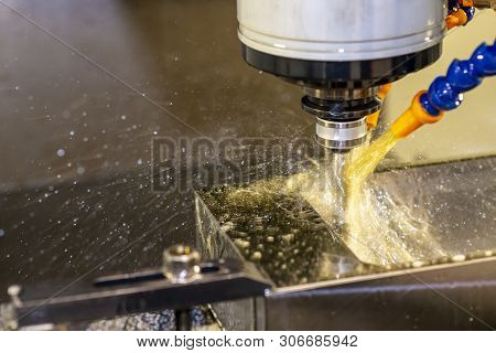 The Cnc Milling Machine Cutting The Injection Mould Parts With The Oil Coolant Method. The Machining
