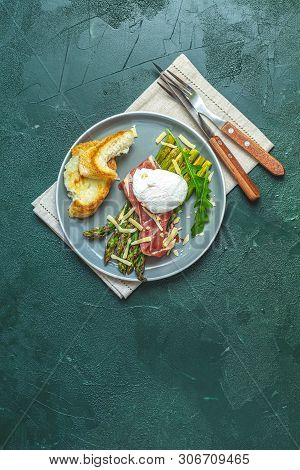 Green Asparagus And Boiled Poached Egg With Hamon (jamon) And Chopped Parmigiano (parmesan) On A Dar