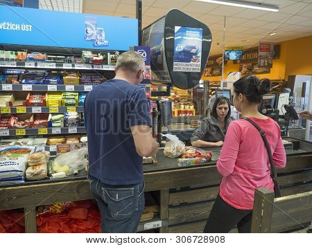 Czech Republic, Cvikov, April 25, 2019: Young Women And Man Shopping And Paying At Cash Desk In Penn