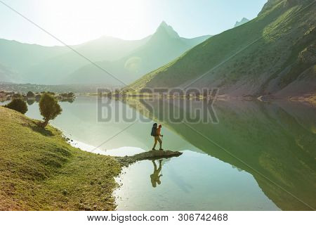 Wanderlust time. Man hiking in beautiful Fann mountains in Pamir, Tajikistan. Central Asia.