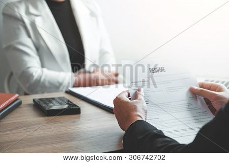 Senior Manager Woman Reading A Resume During A Job Interview Employee Young Man Meeting Applicant An