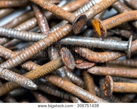 Closeup of pile of old wry rusty nails