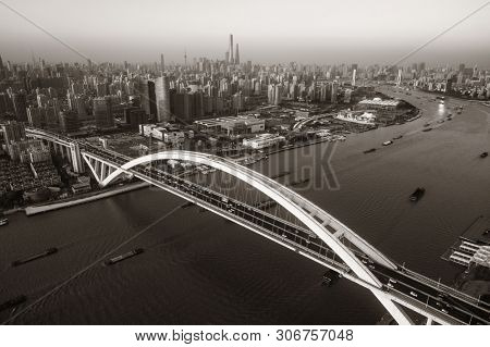 Shanghai Lupu Bridge aerial view over Huangpu River at sunset in China