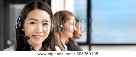 Smiling Beautiful Asian Woman  Working In Call Center With International Team As Telemarketing Custo