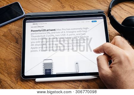 Paris, France - Jun 6, 2019: Man Reading On Apple Ipad Pro Tablet About Latest Announcement Of At De