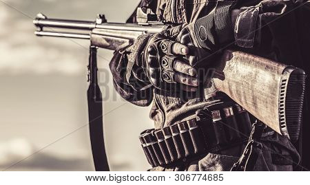 Male With A Gun. A Hunter With A Hunting Gun And Hunting Form To Hunt. Hunter Man. The Man Is On The