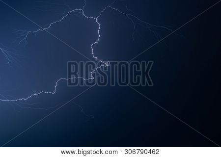 Lightning in the night sky during a severe thunderstorm