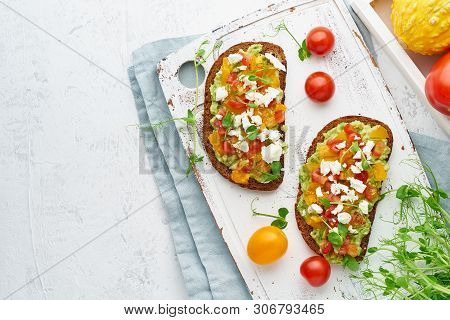 Avocado Toast With Feta And Tomatoes, Smorrebrod With Ricotta, Top View With Copy Space