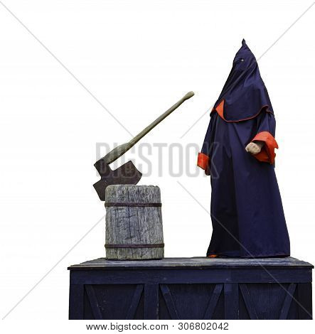 Executioner. Medieval Executioner On The Scaffold In A Black Mantle.