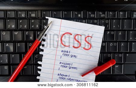 Css. Paper Width Css Code And Pencil On Laptop Keyboard