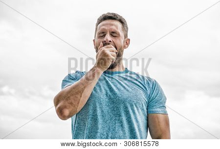 After Workout. Man Athlete In Blue Sport Tshirt. Sportswear Fashion. Yawning Muscular Male With Bear
