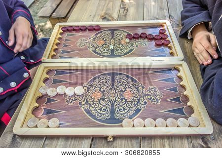 Backgammon Playing Field And Dices On A Vintage Wooden Table Background
