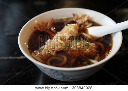 Udon Noodles With Shrimp Tempura On A Bowl