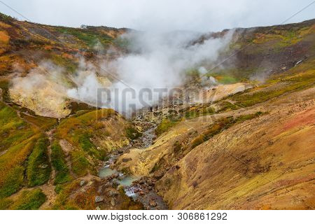 Water Vapor Over The Valley Of Small Geysers. View Of The Eastern Mountain Covered By Clouds, Jelize