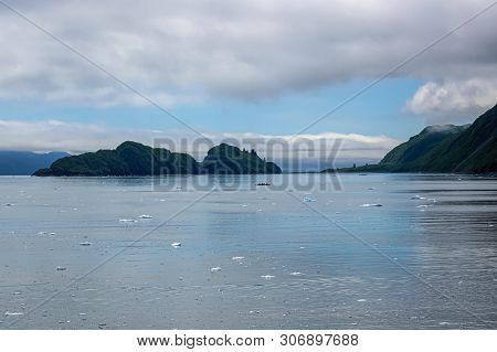 The Ice Field And Distant Kayak In The Aialik Bay, Kenai Fjords National Park In Alaska.