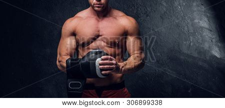 Serious Muskular Man Get Prepared For Boxing, His Is Wearing His Boxer Gloves.