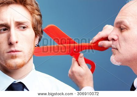 Manager Or Boss Preparing To Snip Off An Earring