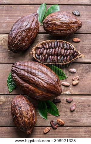 Cocoa pod and cocoa beans on the wooden table. Top view.