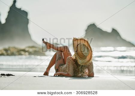 young woman relaxing on the beach in summer day