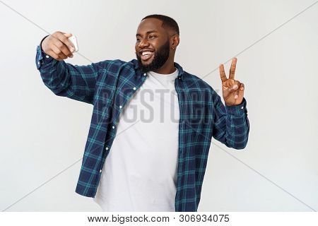 Young Afro American Black Man Smiling Happy Taking Selfie Self Portrait Picture With Mobile Phone.