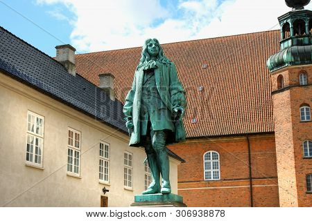 Copenhagen, Denmark: May 1, 2019 - The Statue Of Chancellor Peder Griffenfeld And A Tower In Copenha