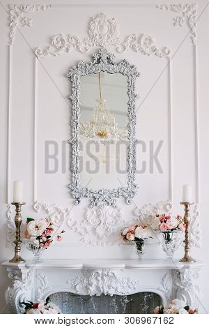 Fireplace And Mirror Over It In The Living Room Area Decorated With Plasterwork And Flowers