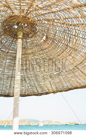 Straw Umbrella On The Beach And Sea Background. Summer Conсept. - Image