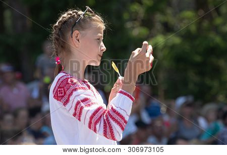 Ivano-frankivsk Reg, Ukraine - Jun. 15, 2019: Girl With A Smartphone At The Festival Polonynsky Summ