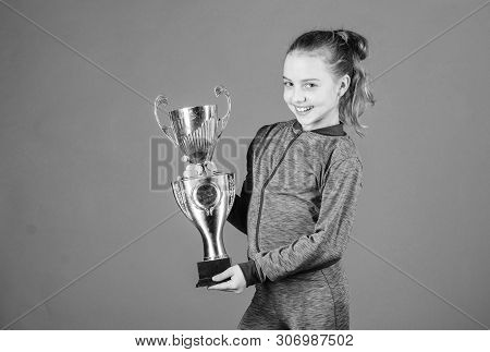 Adorable Cup Winner. Small Girl Holding Silver Cup. Little Child With Cup Shaped Sports Trophy. Cute