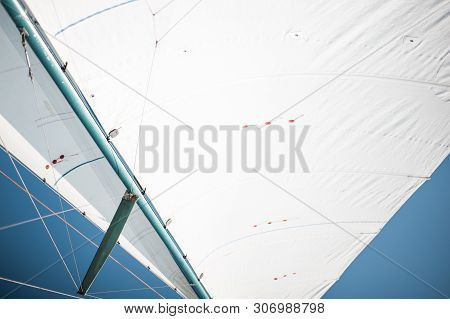 White Cloth Fabric, Masts And Ropes Close-up On The Sail Of Tri-yacht Or Yacht Sailing Boat
