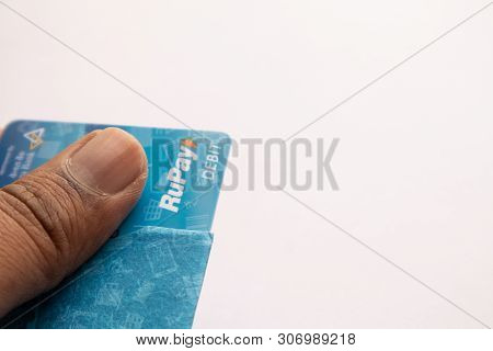 Maski, India - June 18, 2019 : Closeup Of Hands Holding The Rupay Debit Cards On Isolated Background