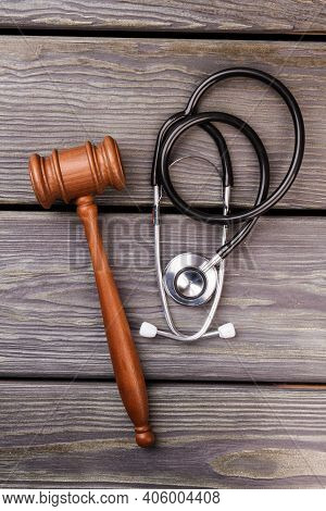Wooden Gavel And Stethoscope. Vertical Shot Top View.