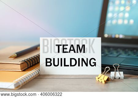 Desktop With Documents, Calculator And Notebook. On A Blockboard Inscription Team Building