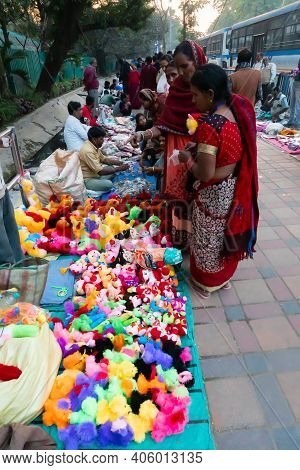 Kolkata, West Bengal, India - 12th January 2020 : Indian Sari Clad Women Buying Toys On Their Way To