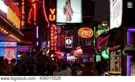Bangkok, Thailand, 13 July 2019: Vivid Neon Signs Glowing On Soi Cowboy Street. Nightlife In Erotic 