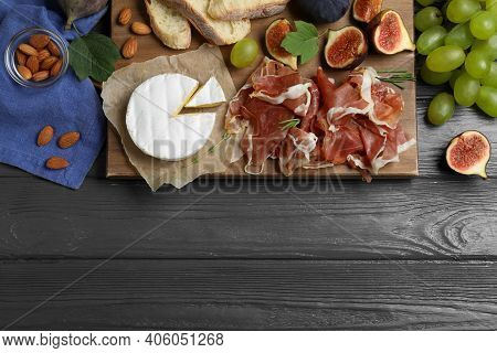 Board With Delicious Figs, Proscuitto, Cheese And Grapes On Grey Wooden Table, Flat Lay. Space For T