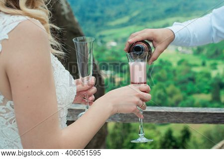 Glasses With Red Champagne Drink. Groom Pouring Wine. Happy Newlyweds Drinking. Loving Couple Create