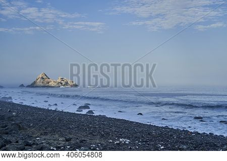 Sunset Over A Guano Covered Rock At The Pacific Coastline Of Peru Along The Panamerican Highway, Sou