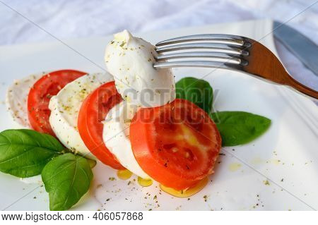 Caprese Salad Made With Fresh Soft White Italian Cheese Mozzarella Buffalo, Green Basil, Red Tomatoe