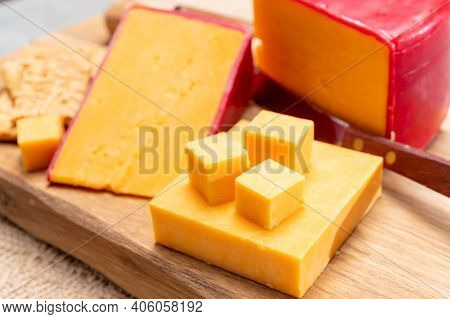 Red Waxed Yellow Cheddar Cheese And Crackers With Grated Cheese
