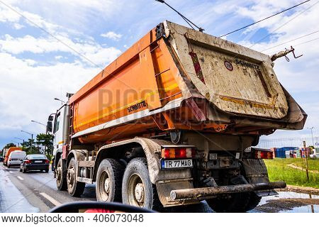 Traffic With Road View Through Car Front Window, Dirty Schmitz Cargobull Tipper Trailer Truck In Tra