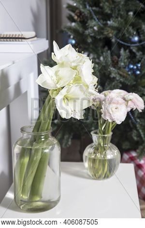 Bouquet Of White Lilies In A Tall Glass Vase On A Beige Table Against A Gray Wall. Copy Space. Fresh