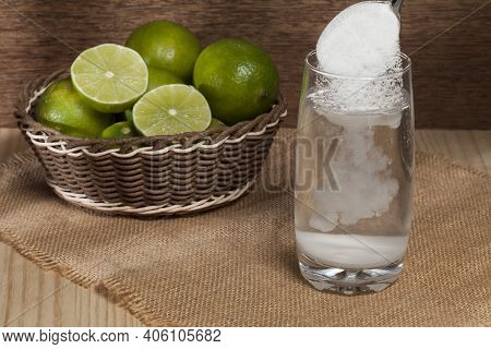 Water, Baking Soda And Lemon; Photo On Wooden Background.