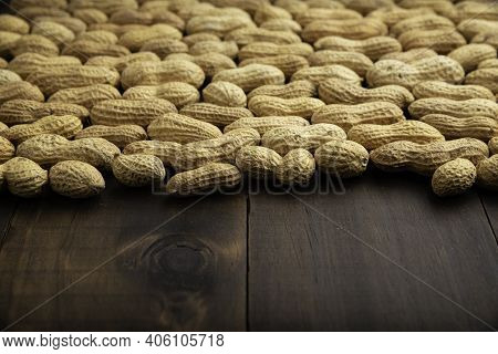 Unpeeled Peanuts On Wooden Table Background With Copy Space. (arachis Hypogaea) Edible Seeds. Health