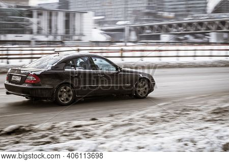 Moscow, Russia - January 15, 2021: Old Black Mercedes W211 On Snowy Winter Road In City. Mercedes-be