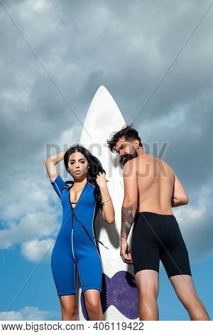 Couple Summer Vacation. Sexy Woman In Bikini. Summertime Concept. Sexy Man In Swimsuit. Surfboard
